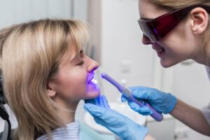 dentist-performing-teeth-whitening-1-scaled.jpg